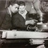 two men inspecting milling machine